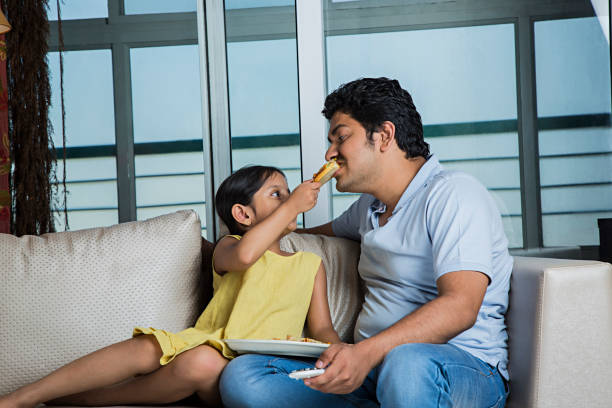 istock Dad and daughter cooking - Stock image 1025443864