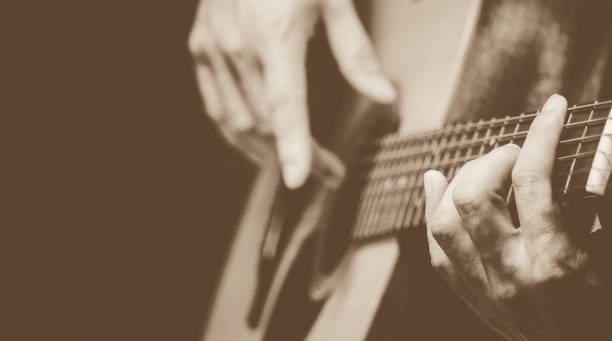 istock male musician hands playing acoustic guitar 1025449074