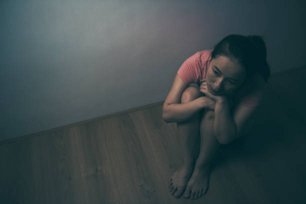 istock sad woman sitting alone in a empty room 1025466940