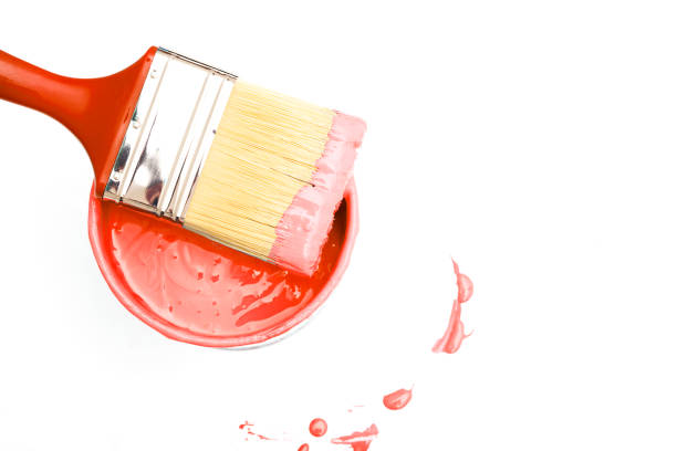 istock open, painted bucket and paintbrush on a white backdrop. 1025467110