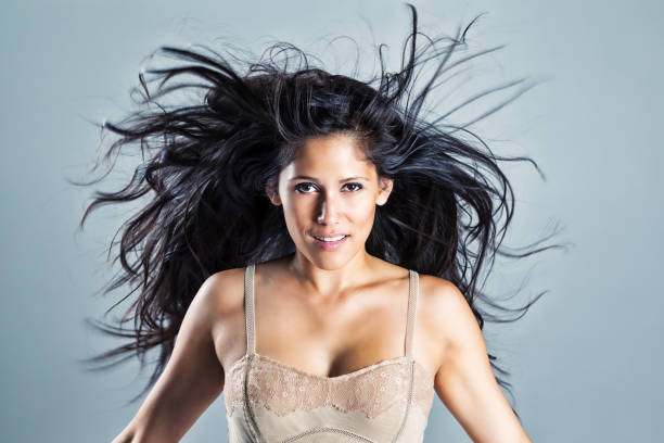 Young woman with beautiful black wind-blown hair Portrait of a beautiful young Native American woman with long, black, wind-blown hair. black hair stock pictures, royalty-free photos & images
