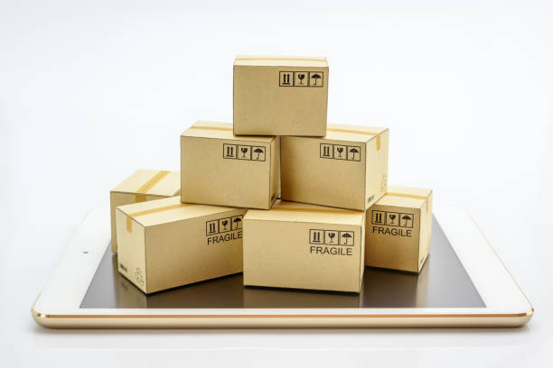 istock International freight service for online shopping or ecommmerce concept : Paper boxes with logos on a white smart mobile phone device. Consumers always shop goods or things online using the internet. 1025474566