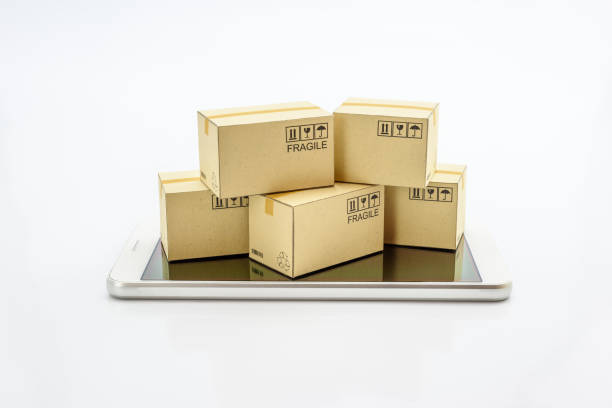 istock International freight service for online shopping or ecommmerce concept : Paper boxes with logos on a white smart mobile phone device. Consumers always shop goods or things online using the internet. 1025474584