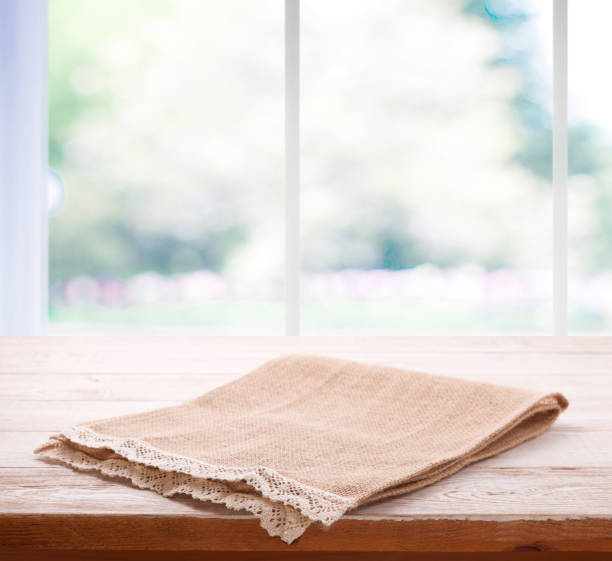 istock Empty tableclothe on the table and kitchen window blurred background. Can used for display or montage your products. Selective fokus. 1025477554