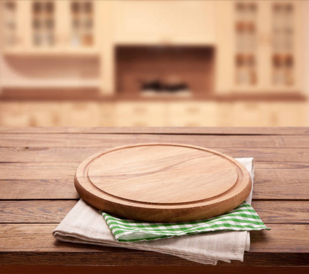 istock Board for pizza and tablecloth on wooden table in kitchen . Top view mock up. Selective focus. 1025477628