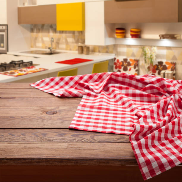 istock Red checkered tablecloth on wooden table. Napkin close up top view mock up. Kitchen rustic background. 1025477640