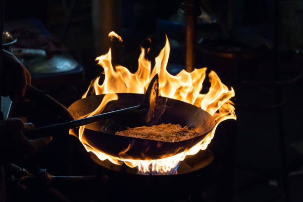 Movement the chef cooking Stir fried rice noodles on stove with flame