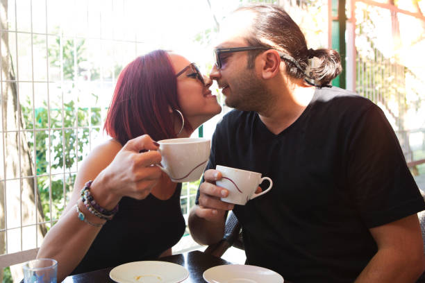 istock Romantic couple drinking coffee ,having a date in the cafe. 1025484376