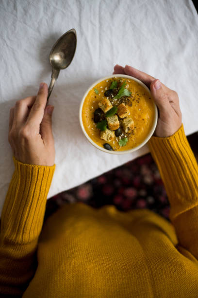 istock Serving roasted-pumpkin soup in a white bowl 1025484432
