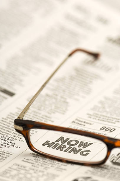 istock Glasses on newspaper ad: Now Hiring 102548776