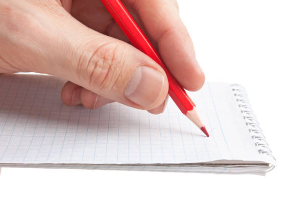 istock red pencil in hand 1025495226