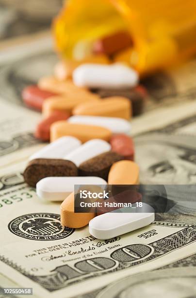 Pills Spilled Over Money Stock Photo - Download Image Now - American One Hundred Dollar Bill, Bottle, Business