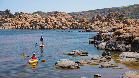 Two women enjoying water activities at Watson Lake nearby Prescott, AZ.
