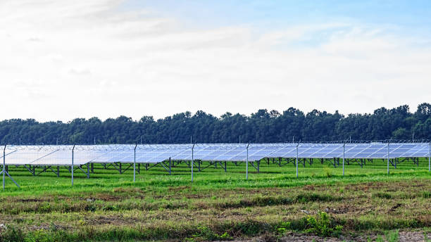 istock Solar panel on blue sky background. Green grass and cloudy sky. 1025505556