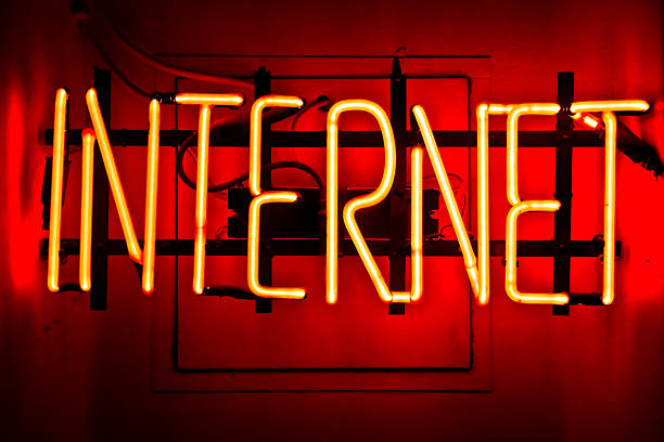 istock Neon yellow light sign that says INTERNET on red background 102550763