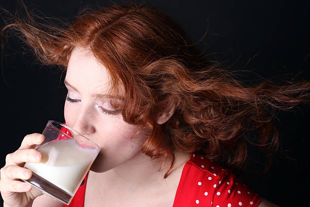 istock Young woman drinking milk 102550983
