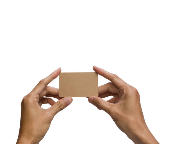 istock Close-up of a man hand holding brown empty card against white background include clipping path. 1025516690