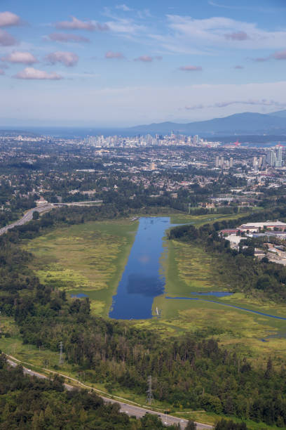 Aerial view of Burnaby Lake in the City with Downtown in the background. Taken in Vancouver, British Columbia, Canada.