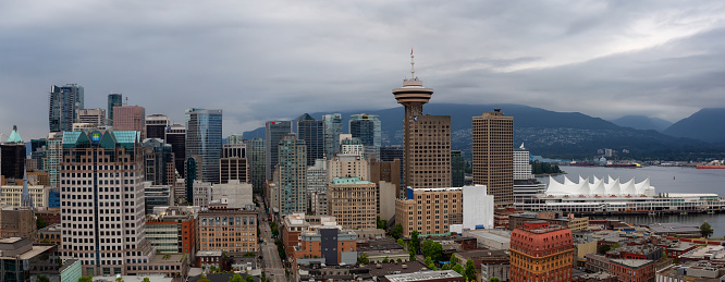 Downtown Vancouver, British Columbia, Canada - June 22, 2018: Aerial panoramic view of the modern City Skyline during a cloudy summer evening.