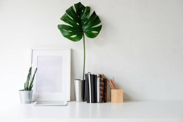 istock Stylish workspace with poster, book and gadget. Workplace desk and copy space. 1025534060