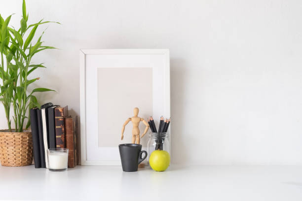 istock Stylish workspace with poster, book and gadget. Workplace desk and copy space. 1025534086