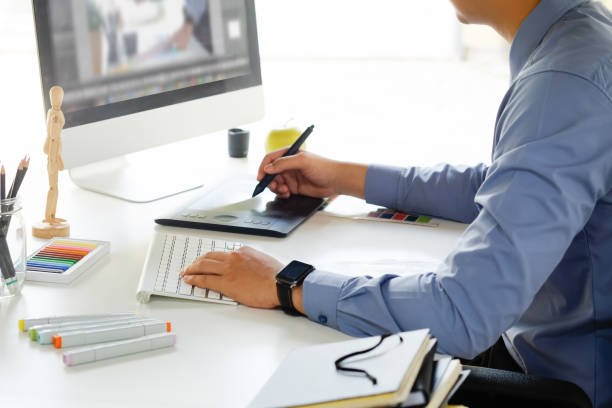 istock Graphic designer working with digital tablet and mouse pen on table and morning light. 1025536172