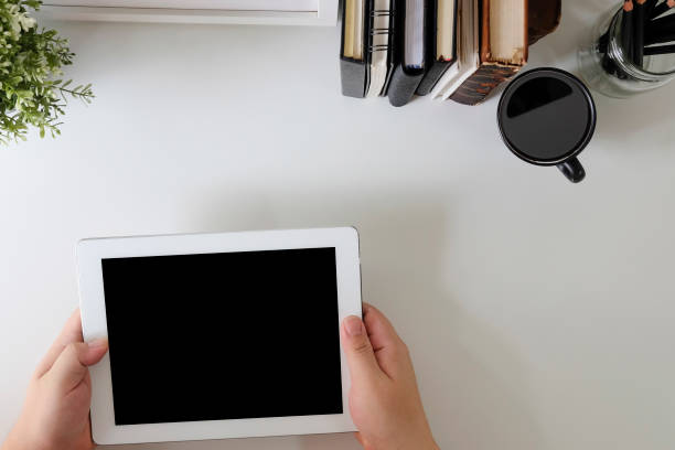 Top view Mockup tablet computer on hands with cropped shot.