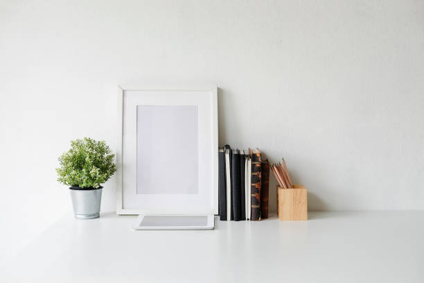 istock Stylish workspace with poster, book and gadget. Workplace desk and copy space. 1025536494