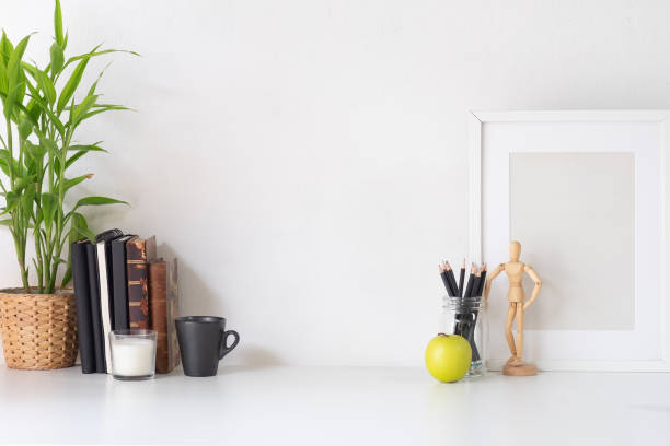 istock Stylish workspace with poster, book and gadget. Workplace desk and copy space. 1025536660