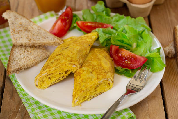 istock Rolled omelette with cheese, vegetable salad and tomatoes 1025536808