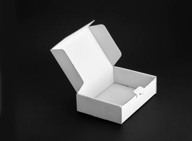 istock Cardboard paper box on a black background 1025539570