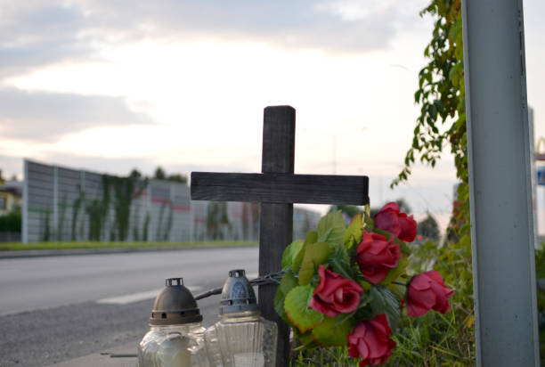 View of roadside memorial with cross, candles and flowers. All Souls' Day View of roadside memorial with cross, candles and flowers. All Souls' Day muerte stock pictures, royalty-free photos & images
