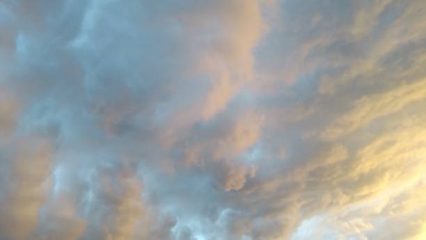 istock Gray pink and orange sunbeam cloudscape 1025555408