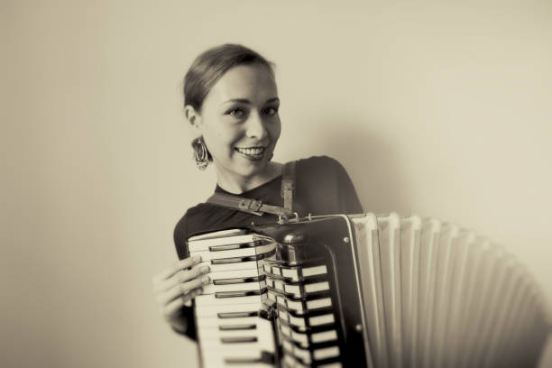 istock Young Woman with old Accordion 1025555640