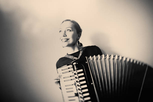 istock Young Woman with old Accordion 1025555648