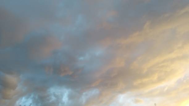 istock Gray pink and orange sunbeam cloudscape 1025560724