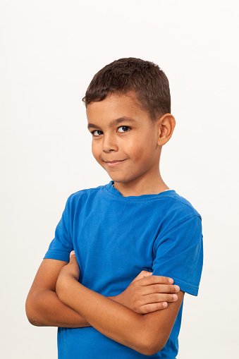 studio portrait of 10 year old schoolboy on white background
