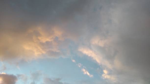 istock Idyllic sunlight thunderstorm cloudscape scenic lightning orange pink gray and blue 1025580960