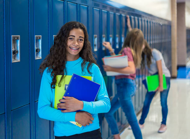 african american female junior high school student portrait, smiling in a school hallway - ring binder fotos imagens e fotografias de stock