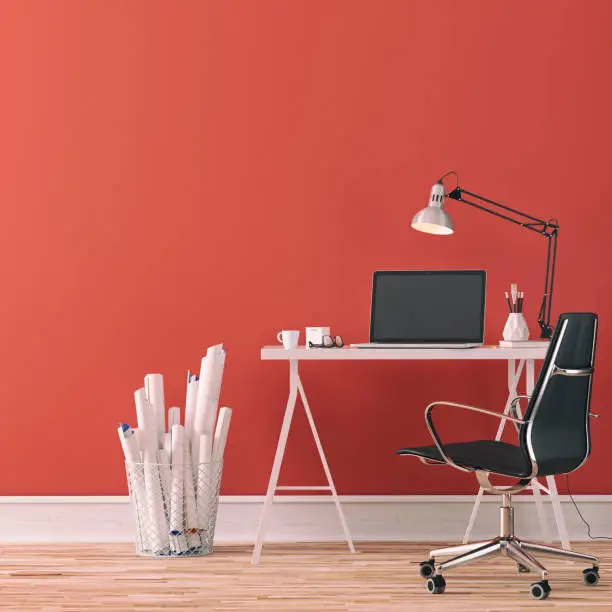 Workdesk with decoration on hardwood floor in front of empty red wall with copy space. 3D rendered image.