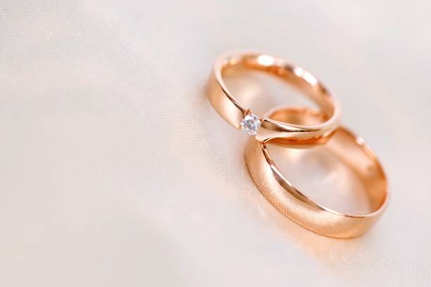 istock Pair Of Wedding Rings On Table 1025613462