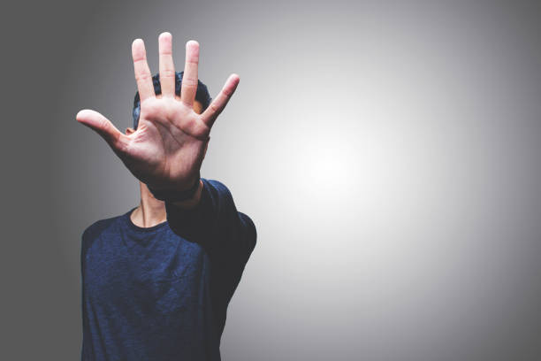istock Mid Adult Man Gesturing While Standing Against Gray Background 1025614196