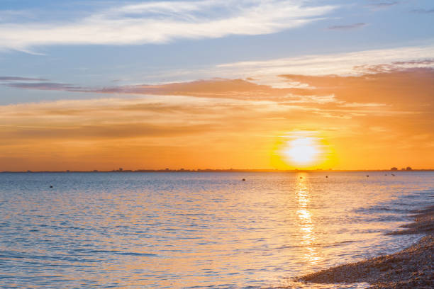 istock Beautiful summer sunset with clouds over the sea 1025614320