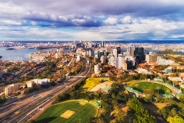 D N Syd Oval 2 CBD Harbour high North Sydney oval with North Sydney high-rise towers along Warringah freeway and further down to SYdney harbour with city CBD in elevated aerial view. north shore stock pictures, royalty-free photos & images