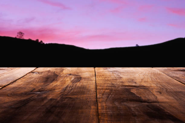istock Empty wooden table against defocused mountain at sunset 1025656644