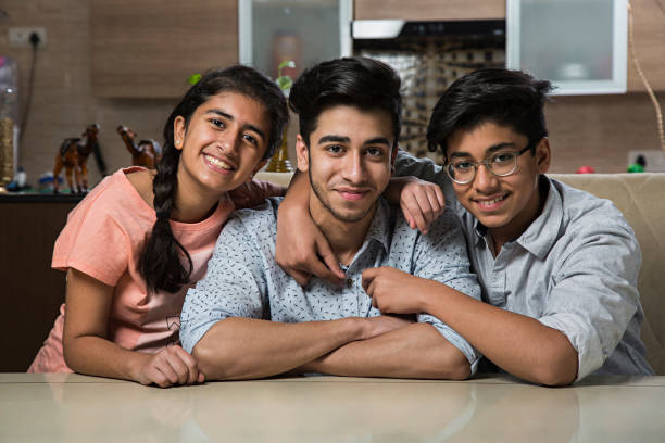 Brother and sister smiling together - Stock image Teenager, Girls, Teenage Boys, Child sibling stock pictures, royalty-free photos & images