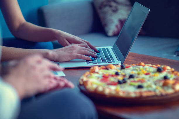 istock Mock up freelancer workplace. Tablet PC, cell phone and pizza. Top view image. Fast pizza delivery 1025657020