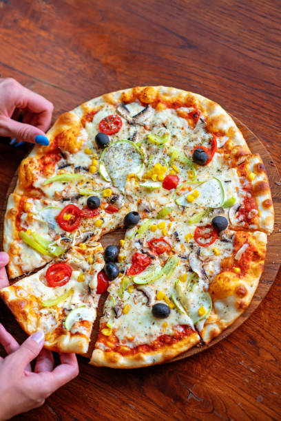 istock Mock up freelancer workplace. Tablet PC, cell phone and pizza. Top view image. Fast pizza delivery 1025658906