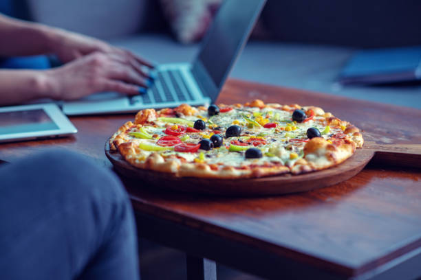 istock Mock up freelancer workplace. Tablet PC, cell phone and pizza. Top view image. Fast pizza delivery 1025672770