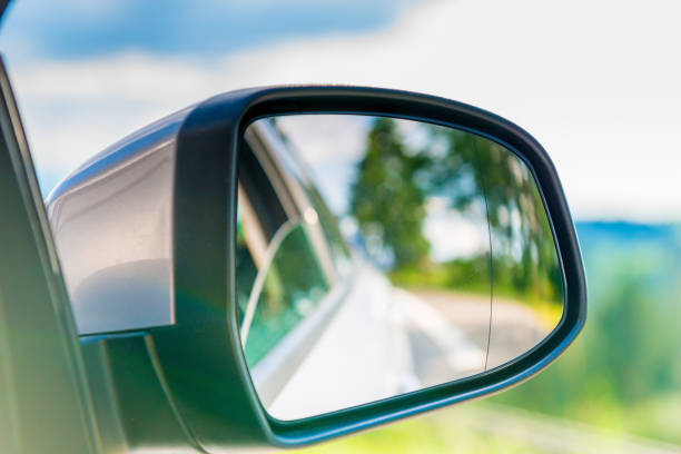 istock car side mirror with a reflection of the beautiful scenery in it, close-up 1025682336